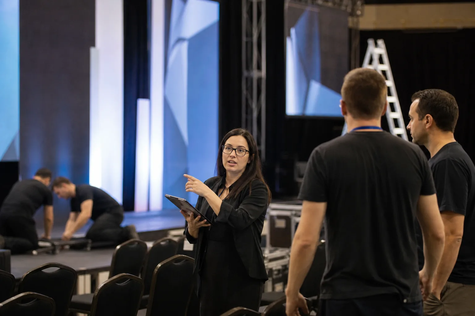 Event planner coordinating a corporate venue setup