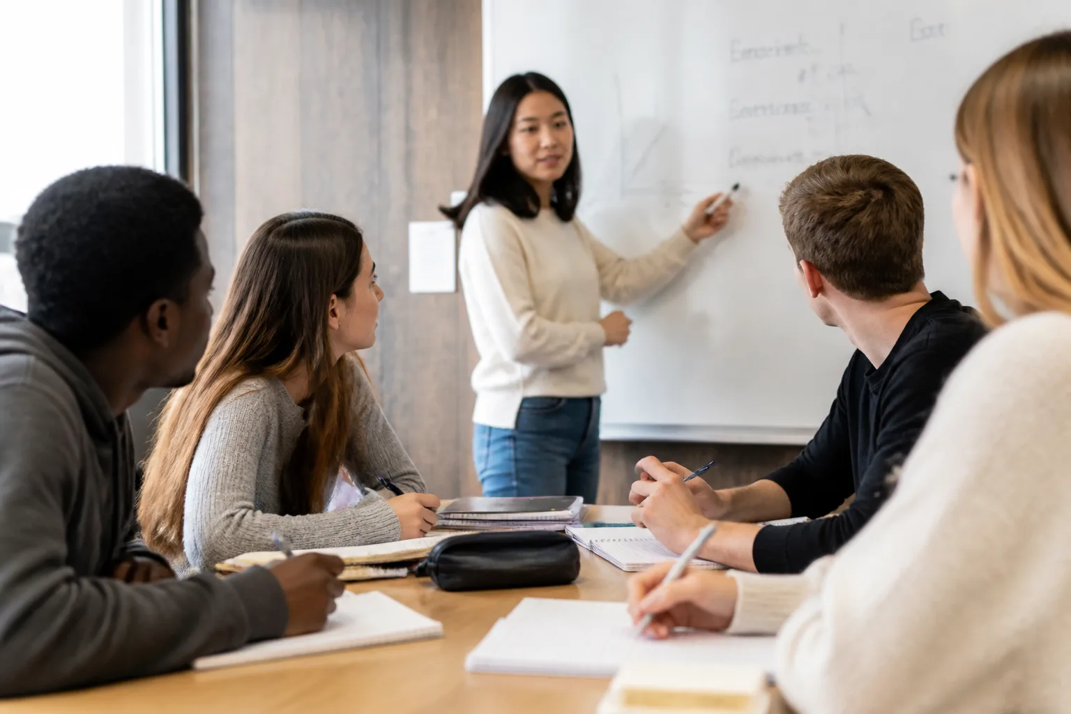 Small group tutoring session around a study table